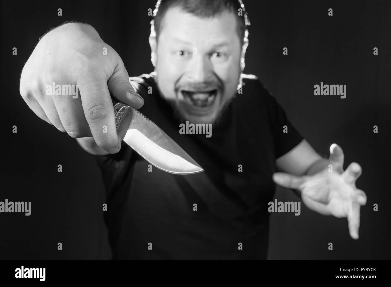 Portrait of a gangster with a knife low key Stock Photo - Alamy