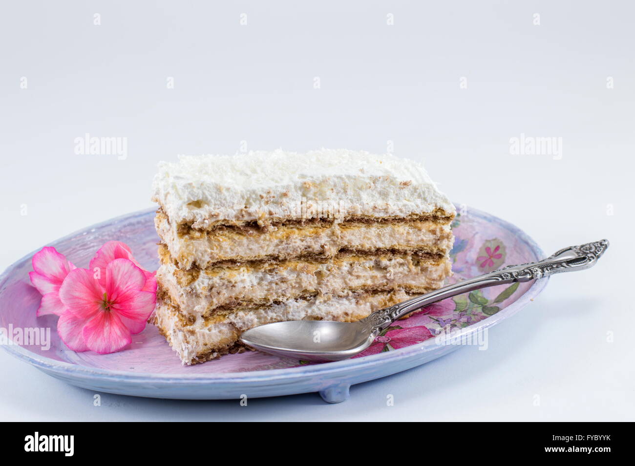 Slice of homemade cake made out of piled biscuits on a plate Stock Photo