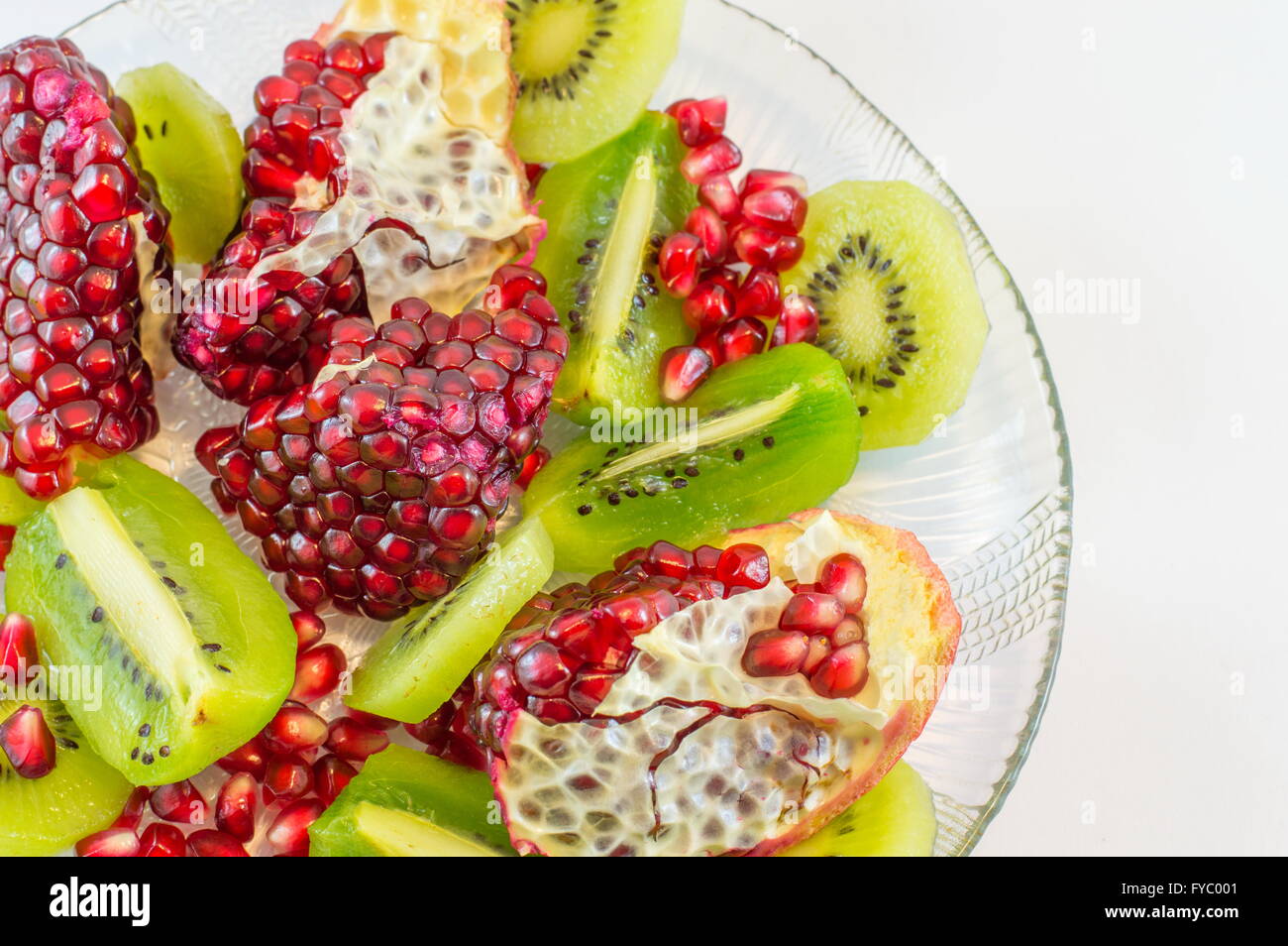 sliced pomegranate and kiwi on a plate Stock Photo