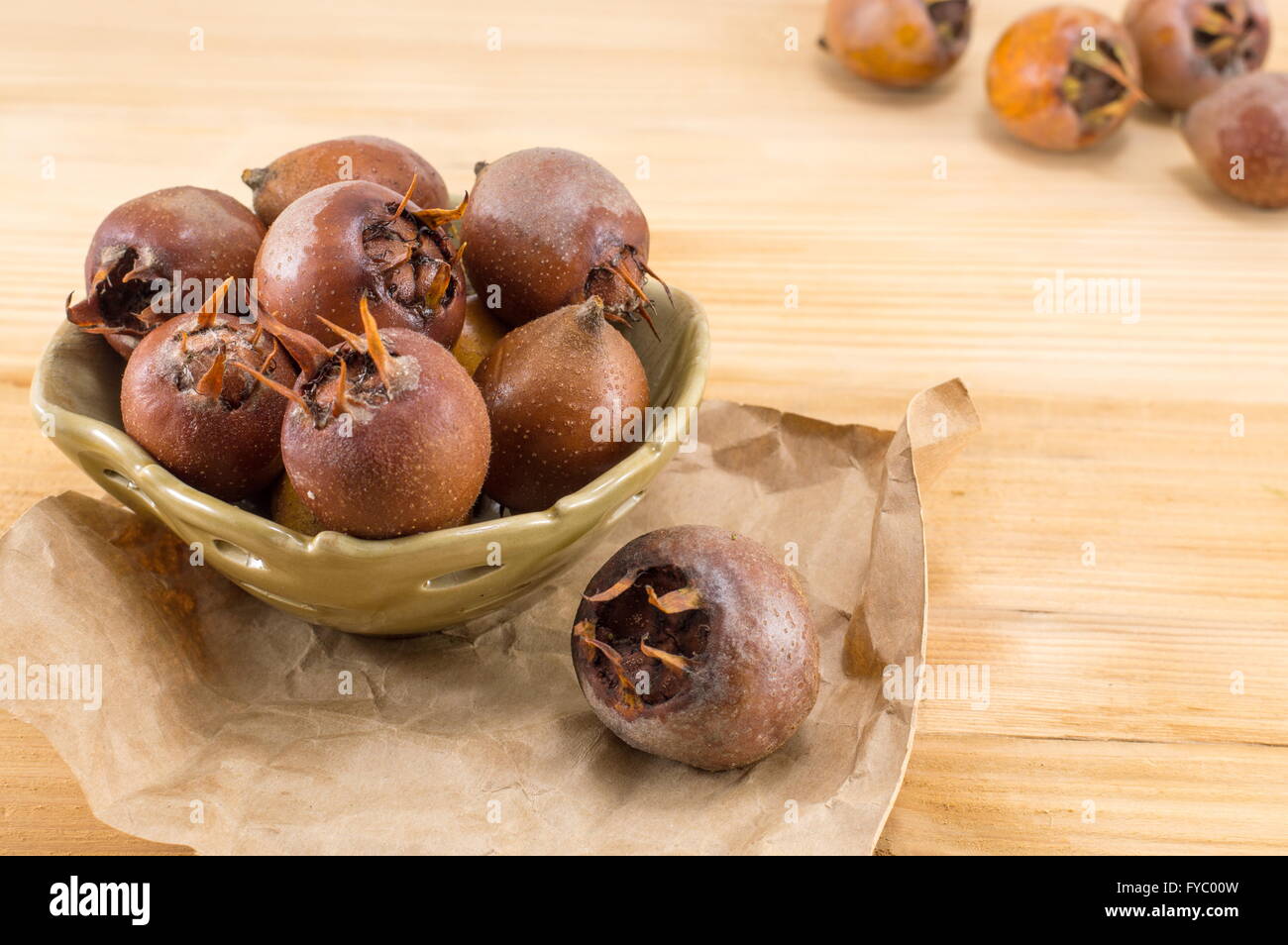 Healthy ripe Medlars on an old wooden table Stock Photo