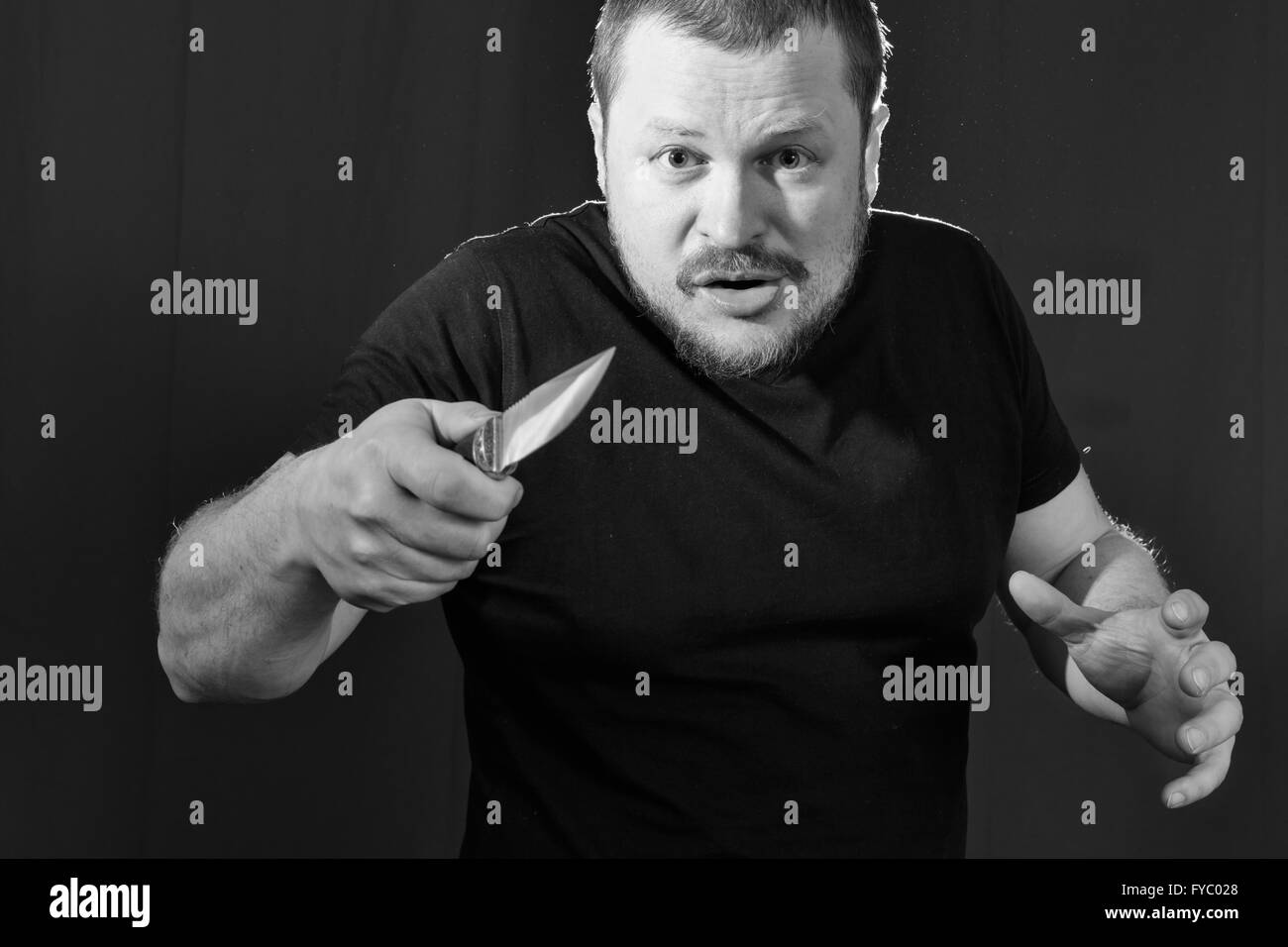 Portrait of a gangster with a knife low key Stock Photo - Alamy