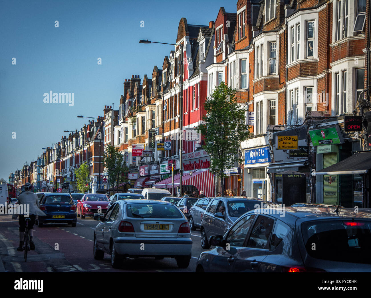 Traffic and shops along Green Lanes, Harringay, North London Stock
