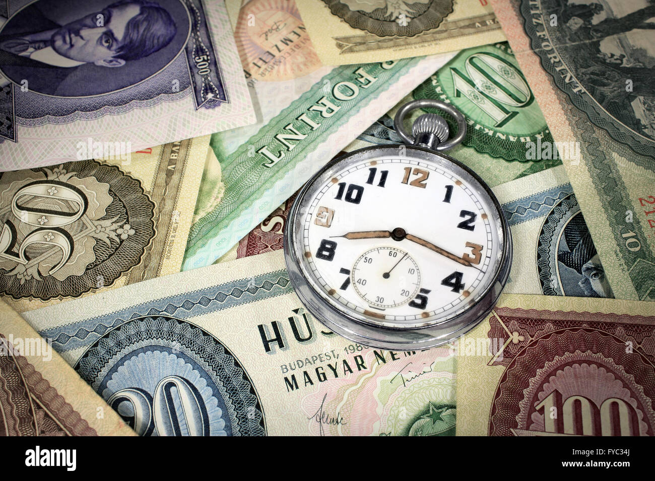 Old hungarian forint money with old pocket watch Stock Photo