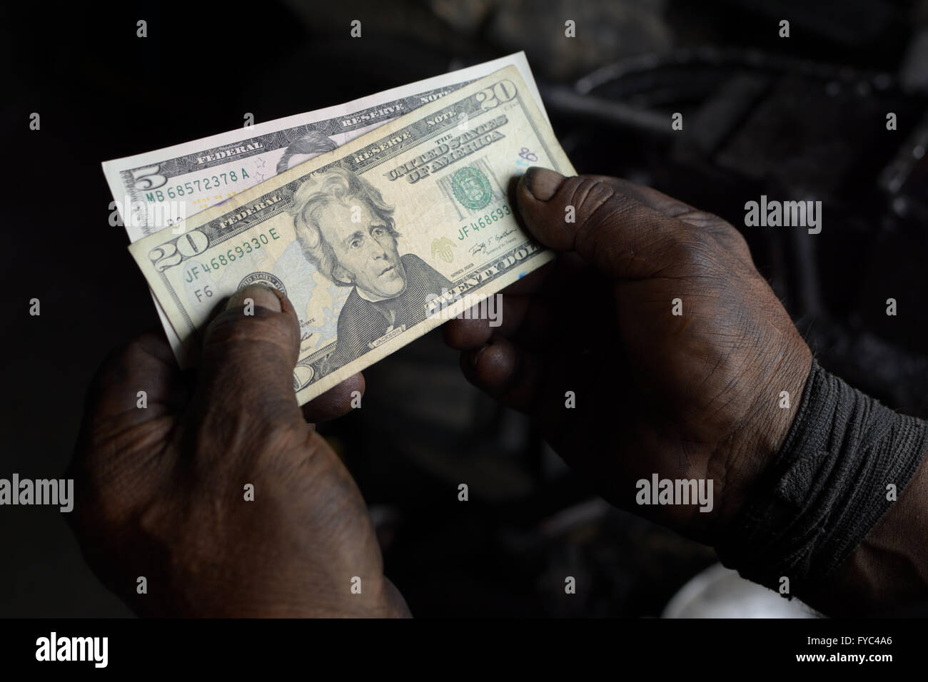 Dirty worker hands with cash money Stock Photo
