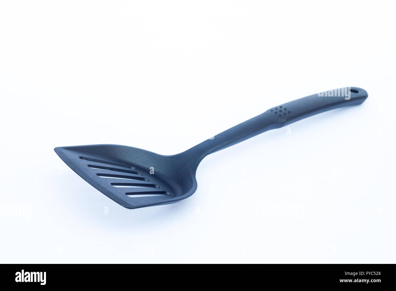 Black plastic kitchen spatula on white background, stock photo Stock Photo