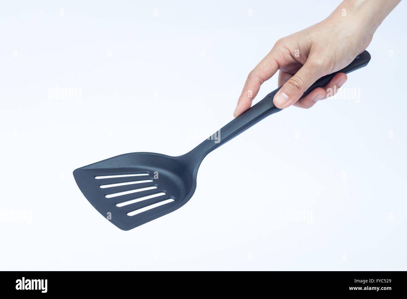 Black plastic kitchen spatula on white background, stock photo Stock Photo