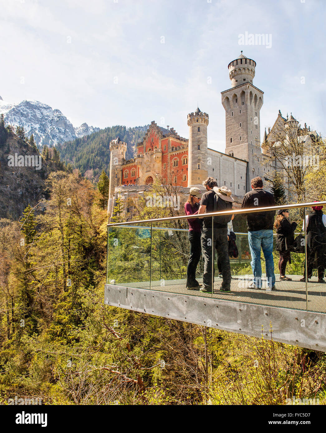 Neuschwanstein, Germany - April 21, 2016:  A group of tourists on a scenic plateau in front of famous Neuschwanstein Castle in B Stock Photo