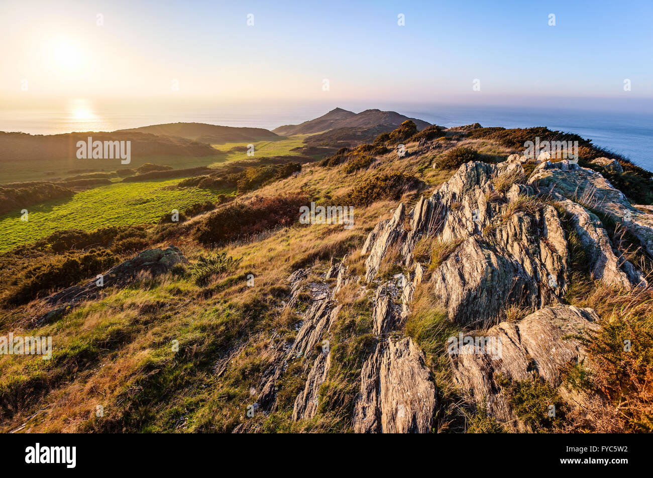 Sun setting over the rocky cliffs at Morte Point in North Devon, England, UK. HDR image created by combining 3 photographs. Stock Photo