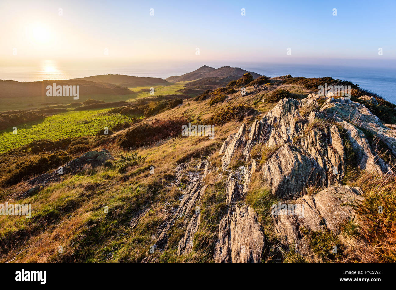 Sun setting over  the rocky cliffs at Morte Point in North Devon, England, UK. HDR image created by combining 3 photographs. Stock Photo