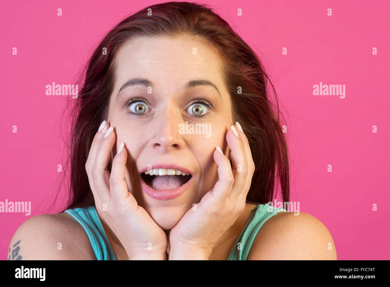 Surprised woman hands on face Stock Photo