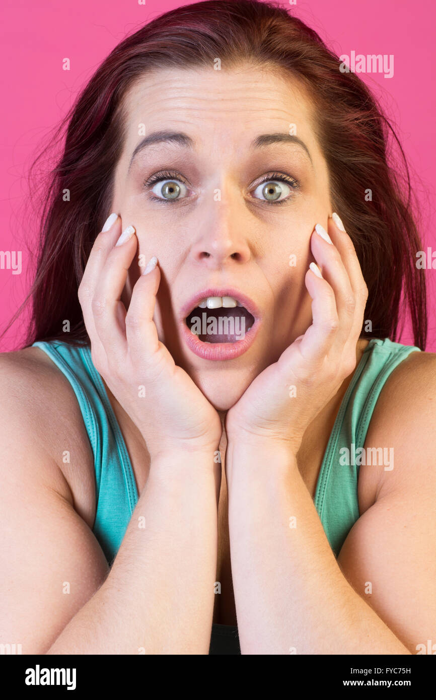 Surprised woman hands on face Stock Photo
