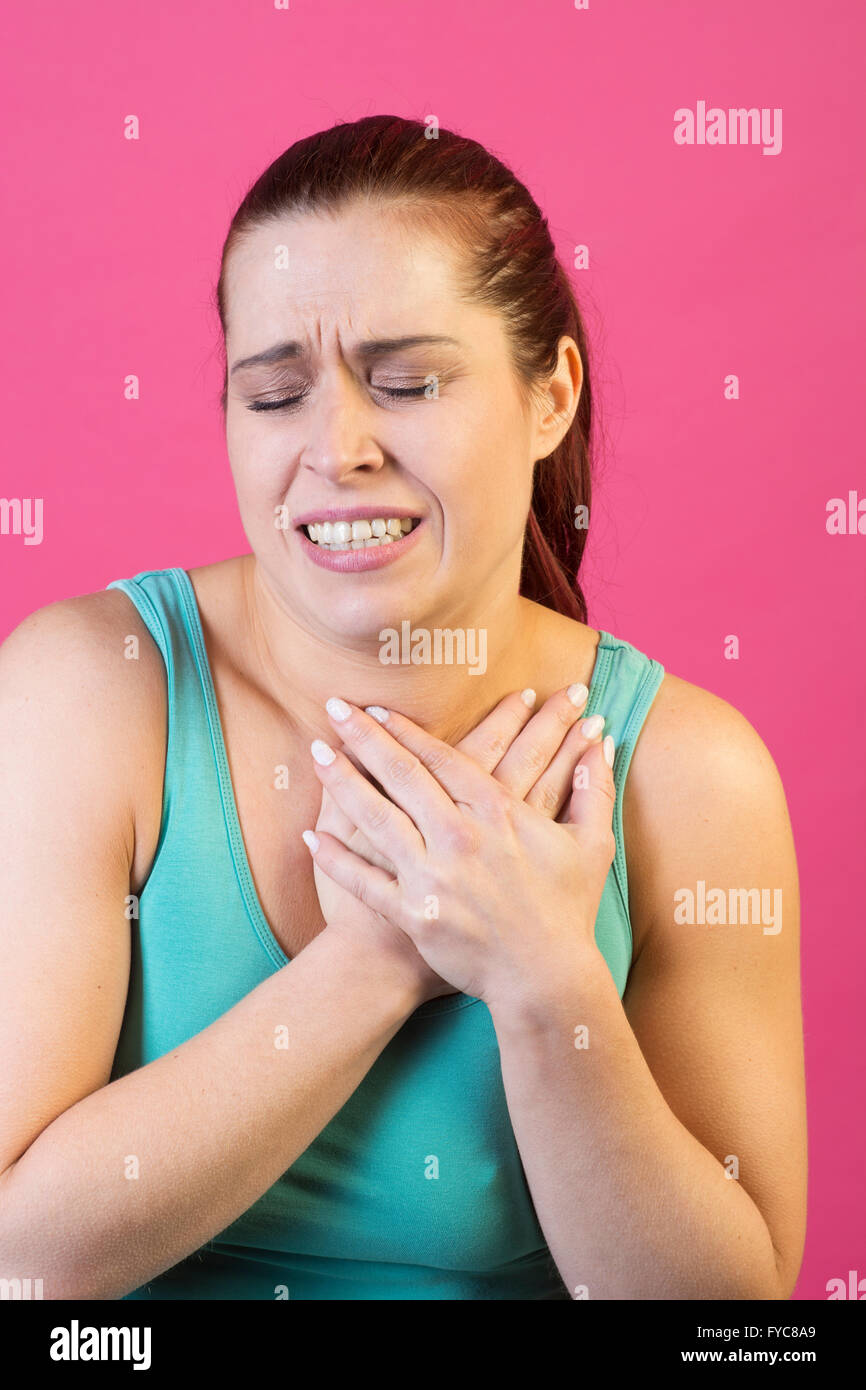 Woman hands over heart in pain Stock Photo