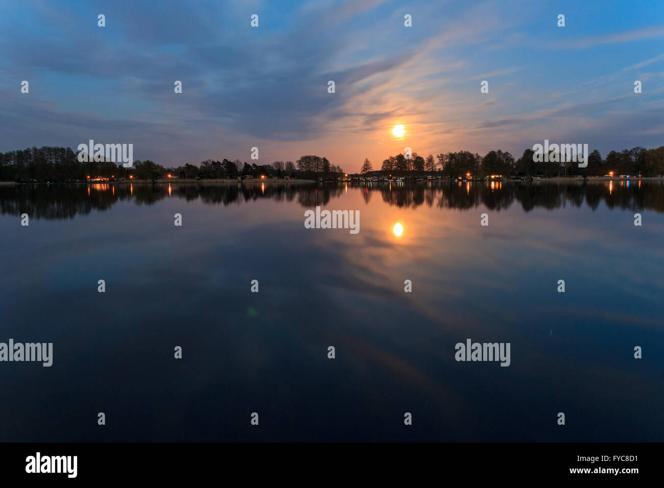 rural landscape at night with full moon and lake reflection Stock Photo