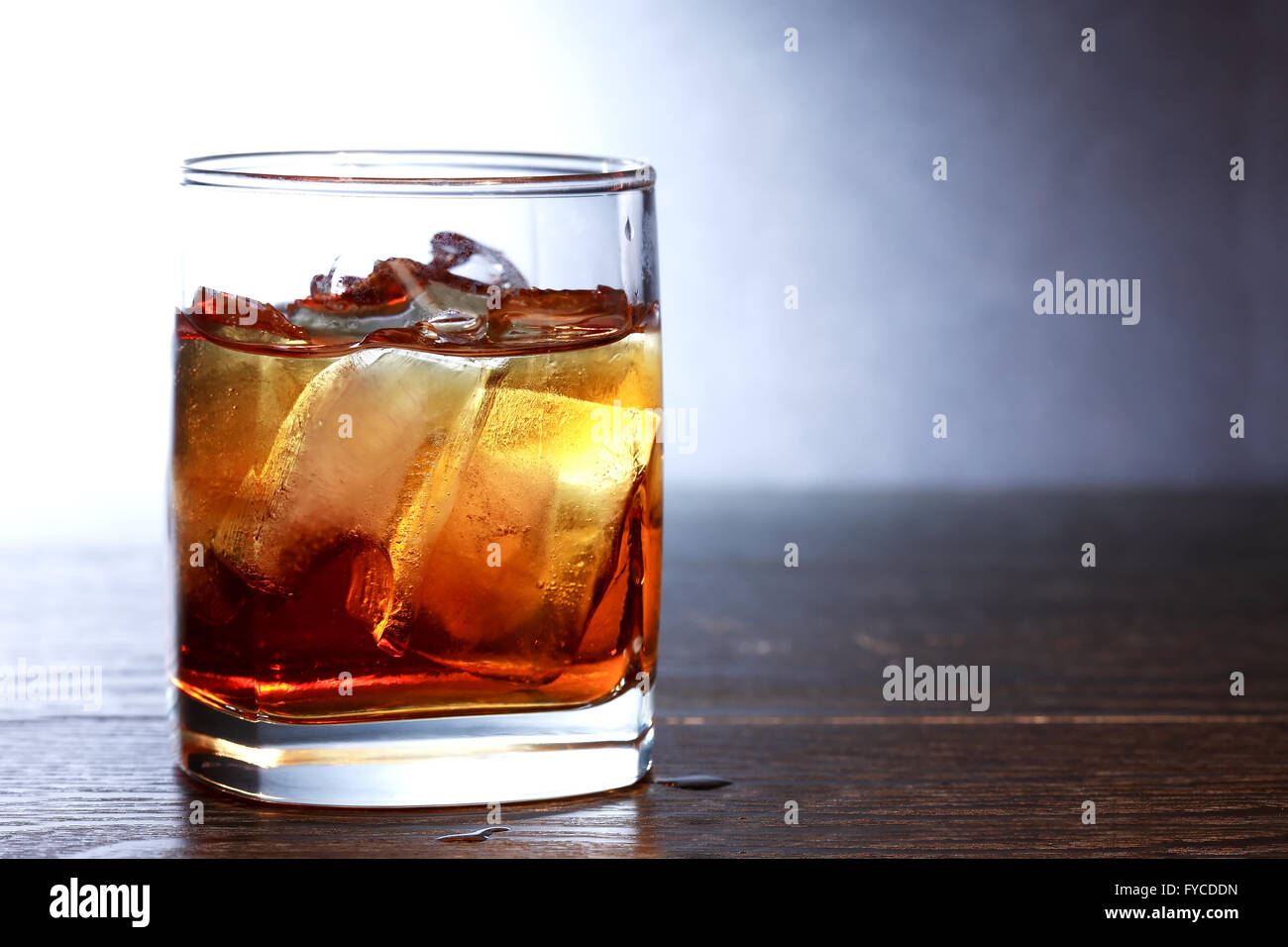 Evening drink. Whiskey with ice on nice dark background Stock Photo