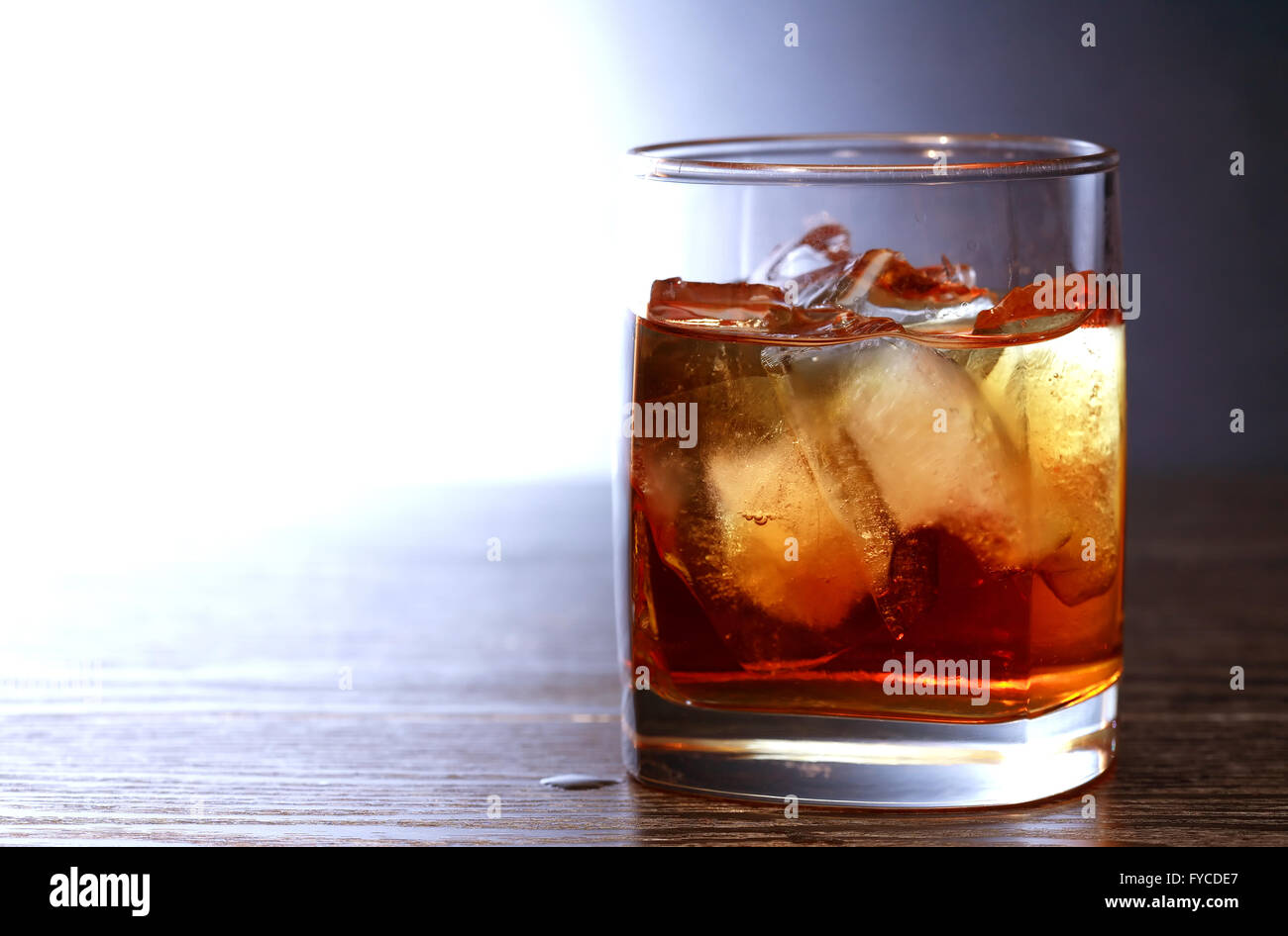 Evening drink. Whiskey with ice on nice dark background Stock Photo