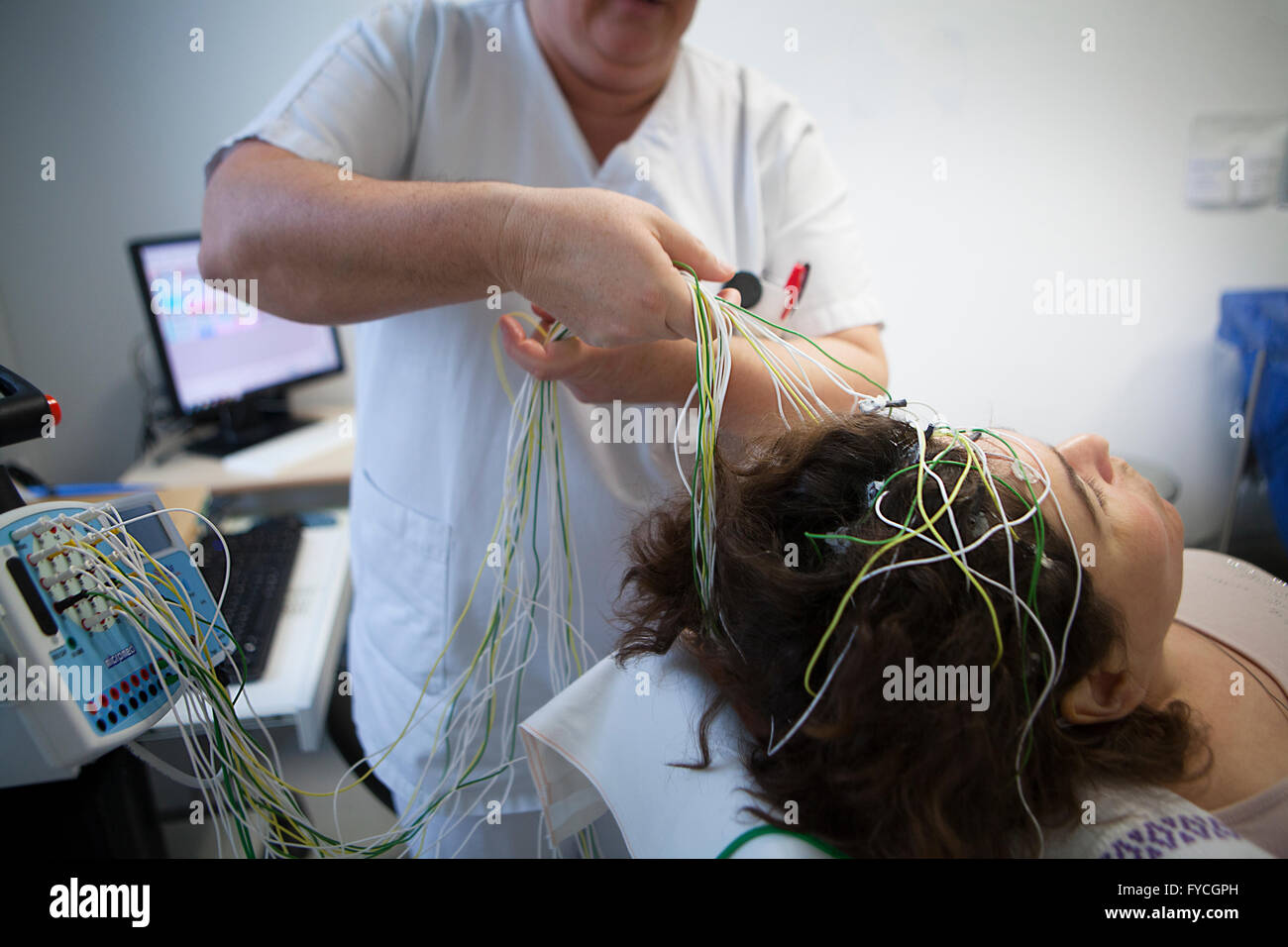 Woman undergoing electroencephalogram eeg hi res stock photography and