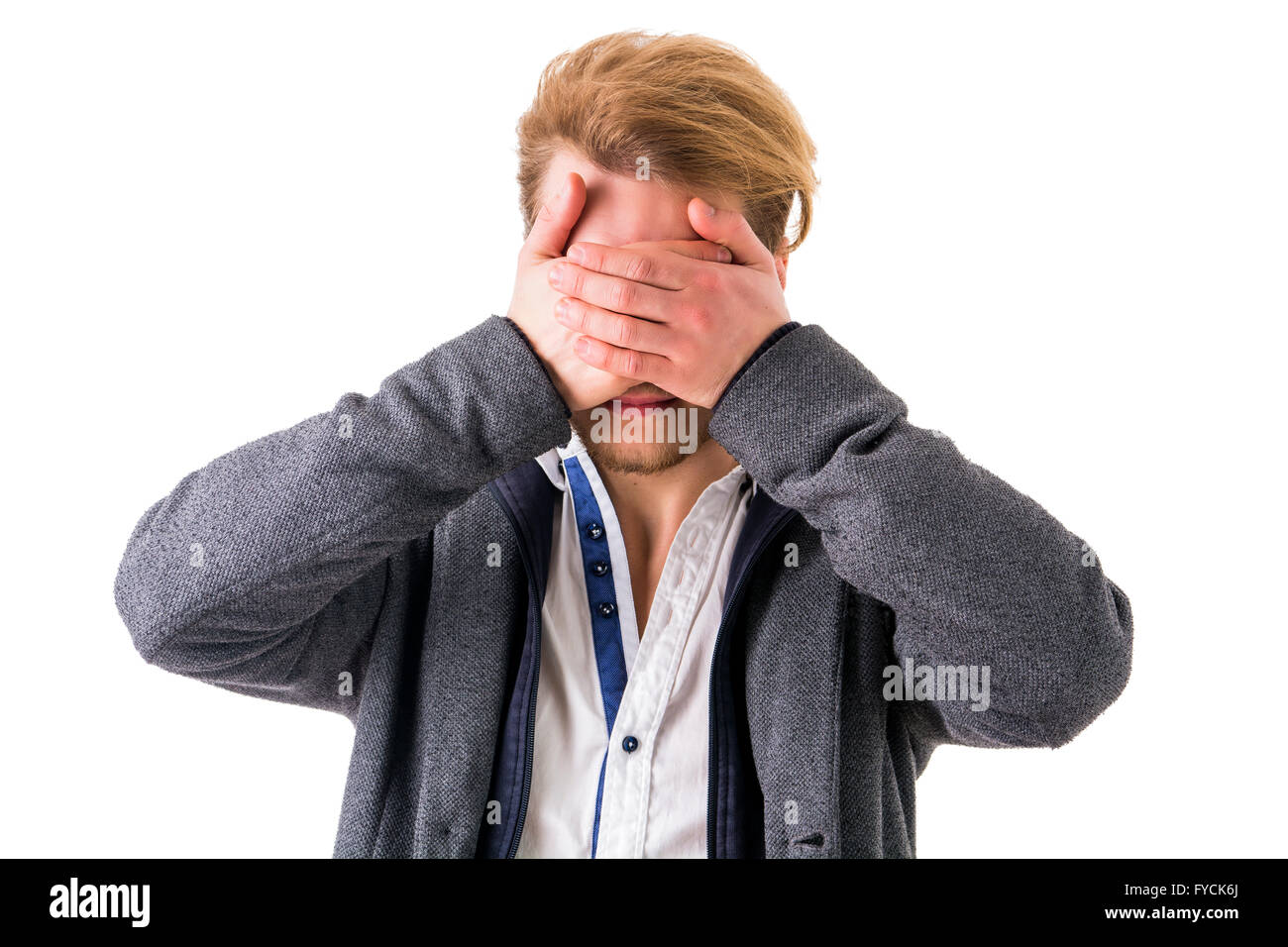 Young unrecognizable man with blond hair covering eyes with hands.White background.Isolated Stock Photo