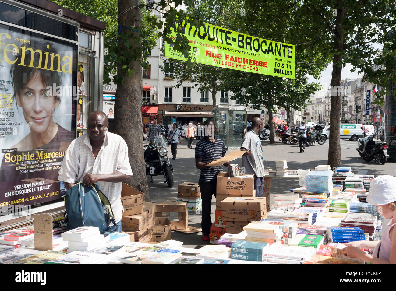 Mans selling books seen in the street in Paris. France.  Pic Pako Mera Stock Photo