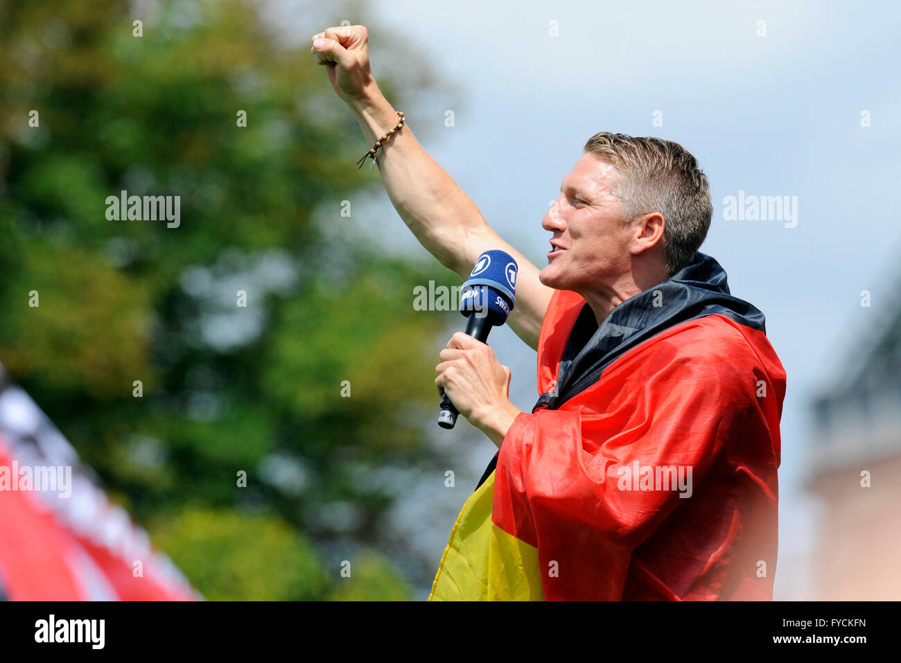 Bastian Schweinsteiger, wrapped in the Germany flag, reception of the German national team after their victory at the FIFA World Stock Photo