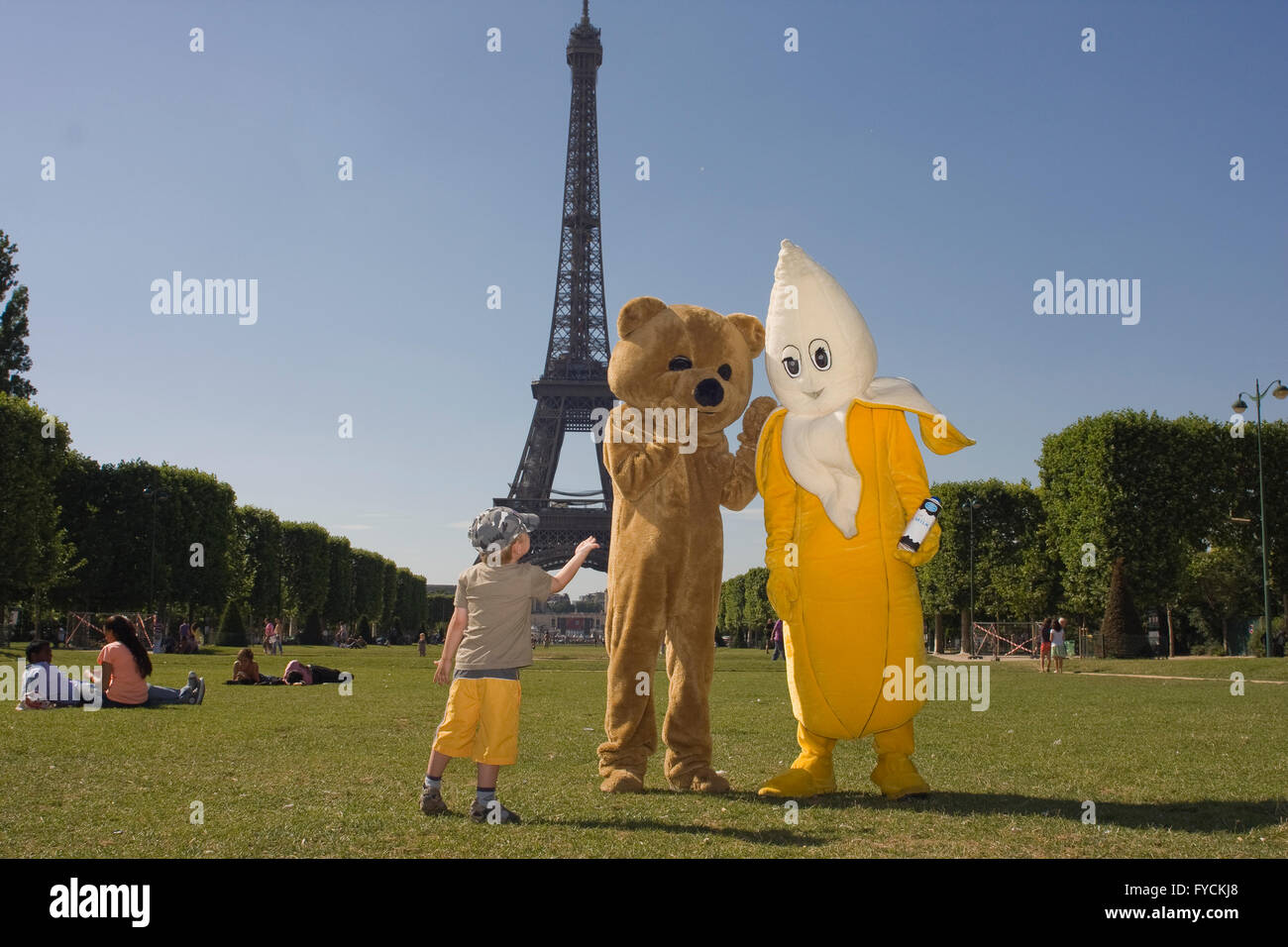 Children get attraction of a couple who wearing a fancy dress in The Eiffel Tower. Stock Photo