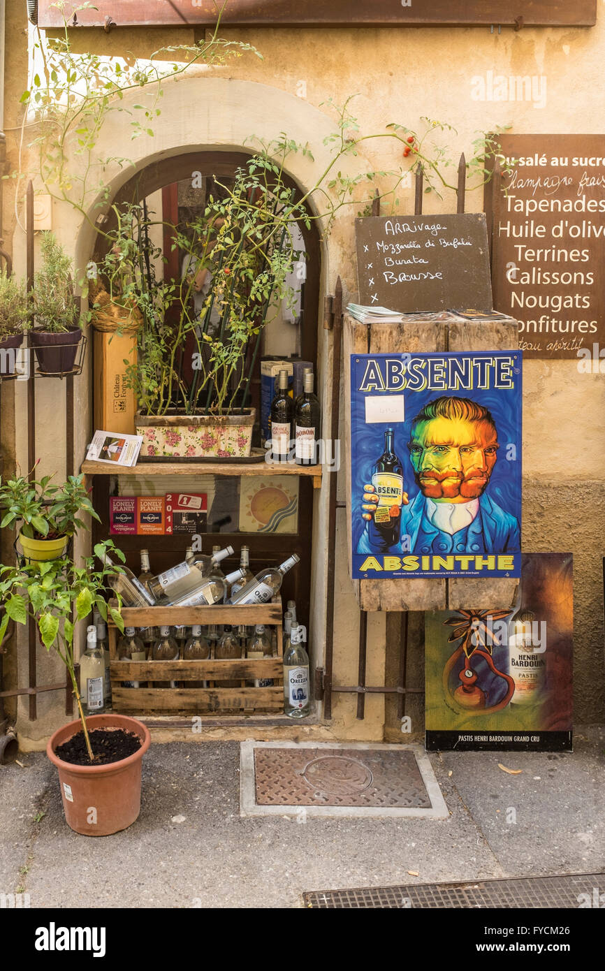 Village shop with a poster of Van Gogh holding a bottle of Absinth, Lourmarin, Vaucluse, Provence-Alpes-Côte d'Azur, France Stock Photo