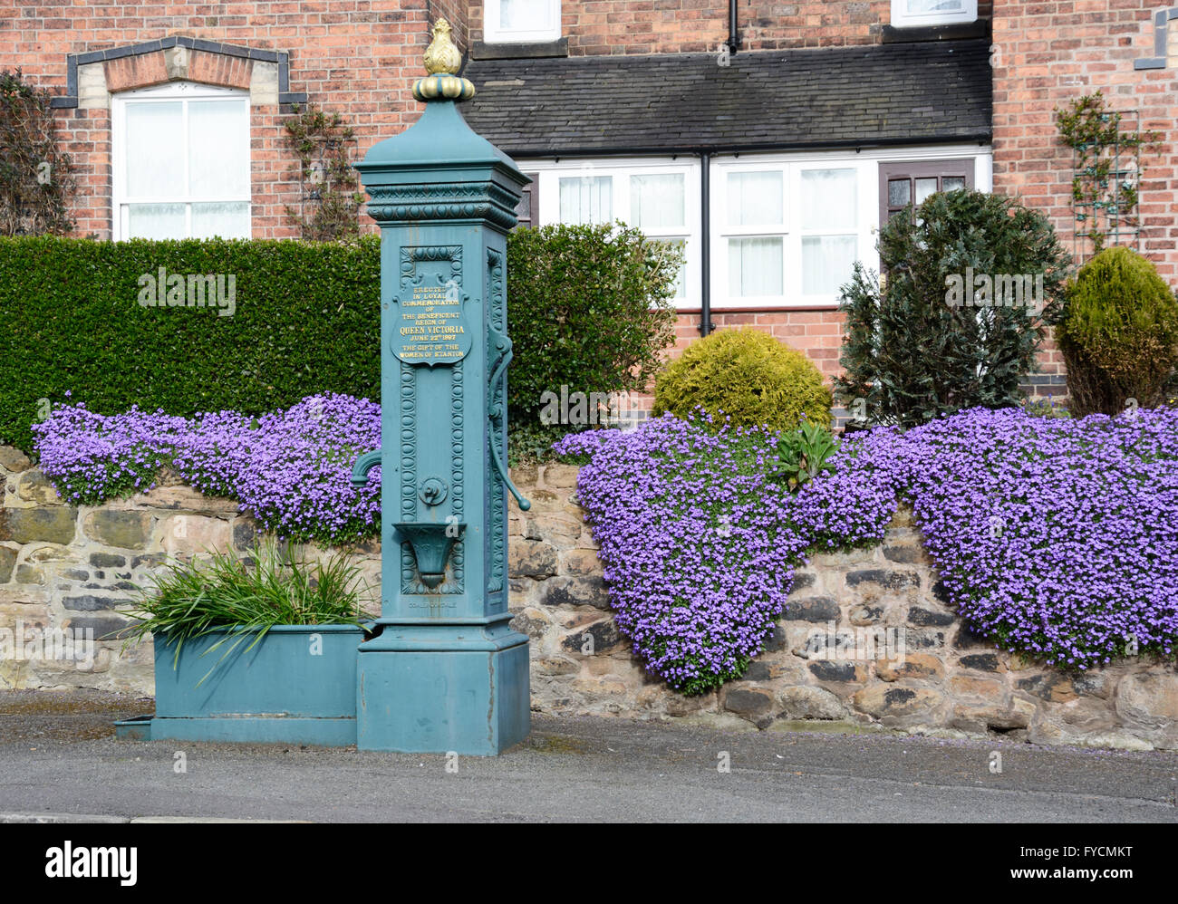 Victorian pump & wisteria, in Stanton by Dale village, Derbyshire, Stock Photo