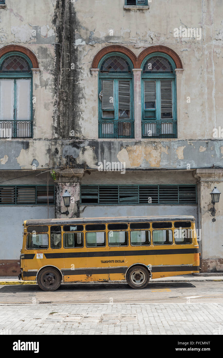 Old yellow school bus parked up in Old Havana, Cuba. Stock Photo