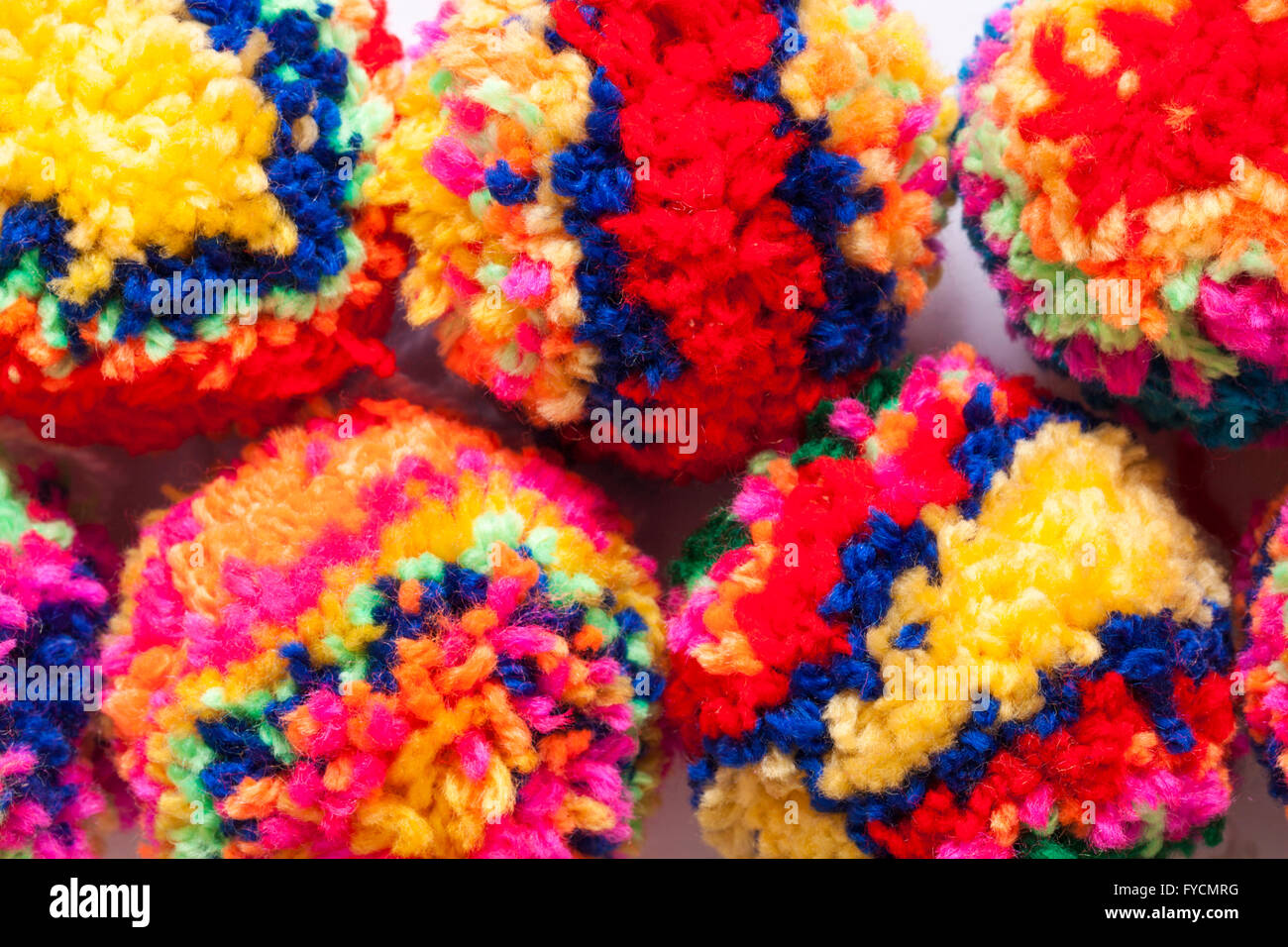 multicoloured home made poms poms made of brightly coloured wool