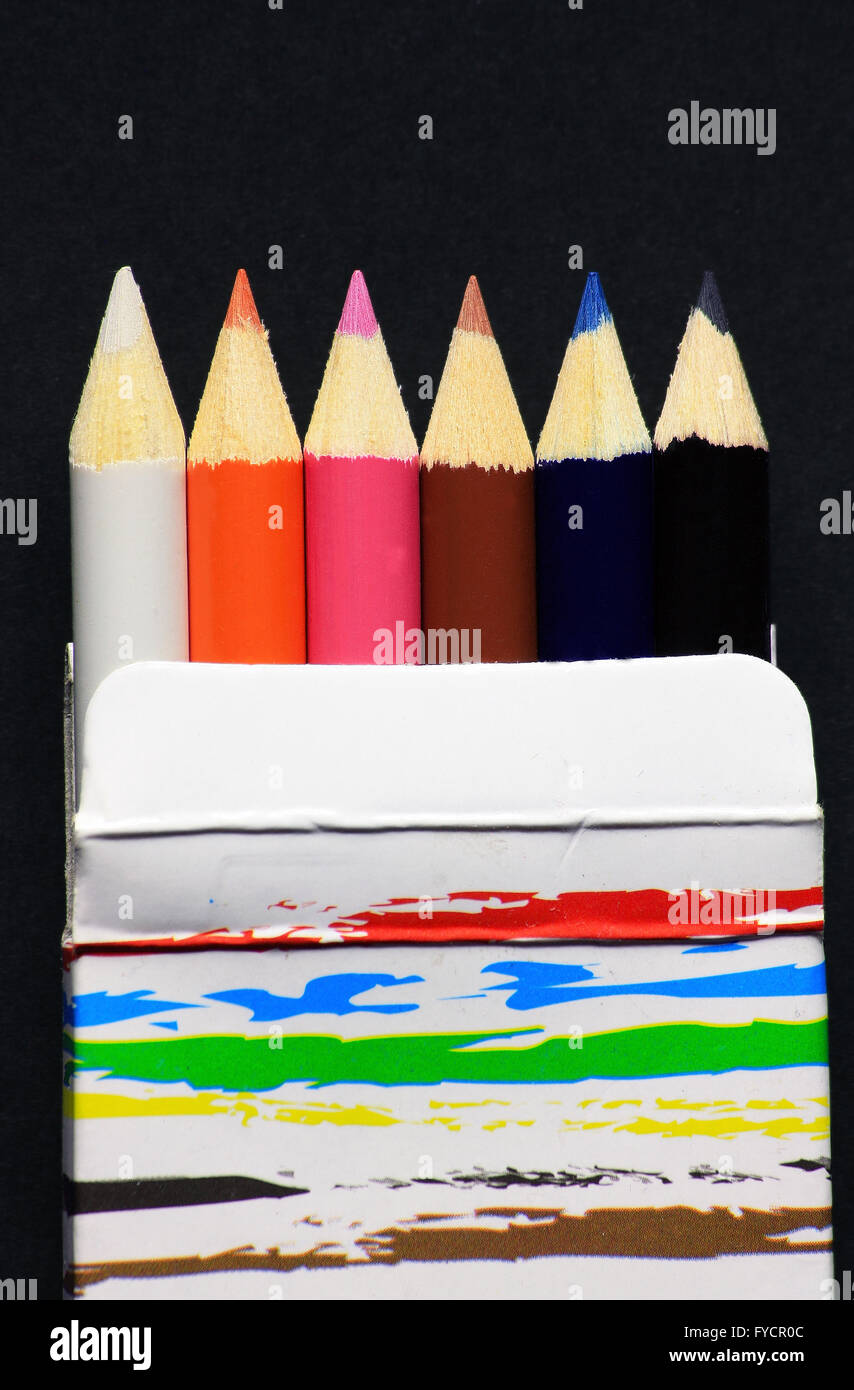 Color pencils in paper box on dark background Stock Photo