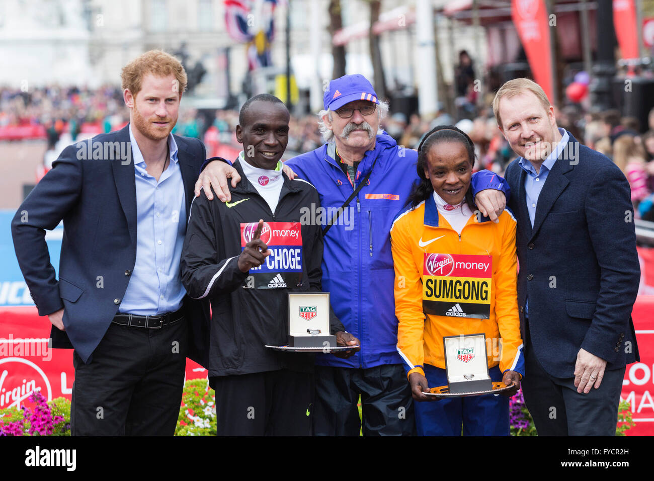 London, UK. 24 April 2016. HRH Prince Harry of Wales and marathon officials  pose with the winners Eliud Kipchoge (KEN) and Jemima Sumgong (KEN). The  2016 Virgin Money London Marathon finishes on
