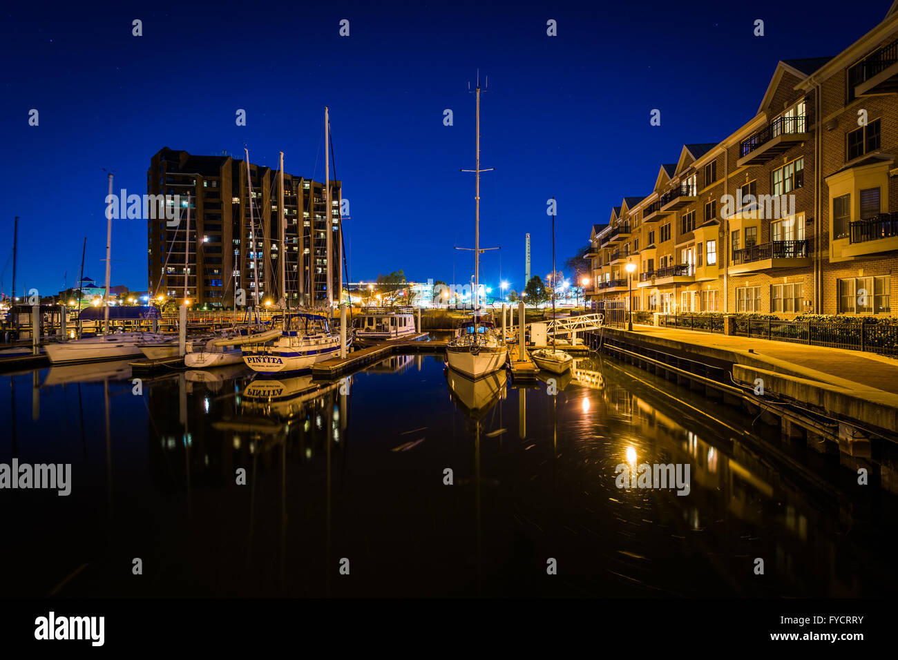 Marina and apartment buildings on the waterfront at night, in Canton, Baltimore, Maryland Stock