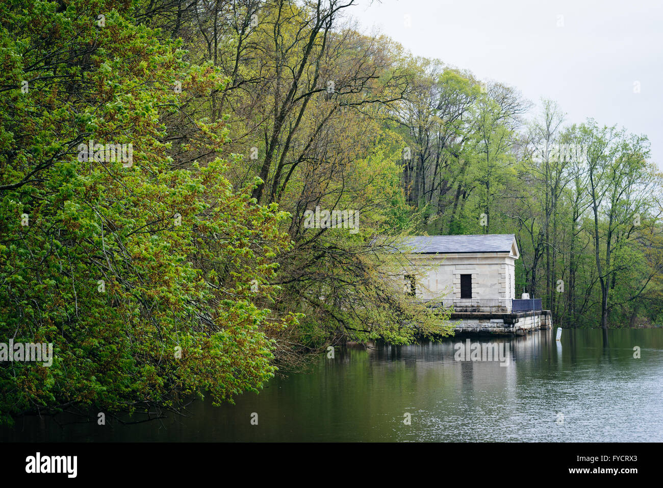 Spring color and building along Lake Roland, at Lake Roland Park, in Baltimore, Maryland. Stock Photo