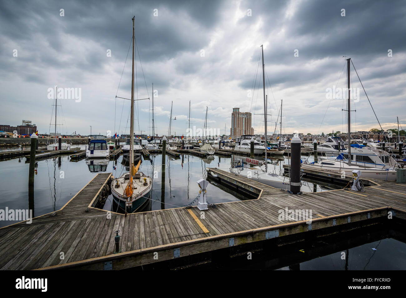 Storm clouds over docks and boats in Harbor East, Baltimore, Maryland. Stock Photo