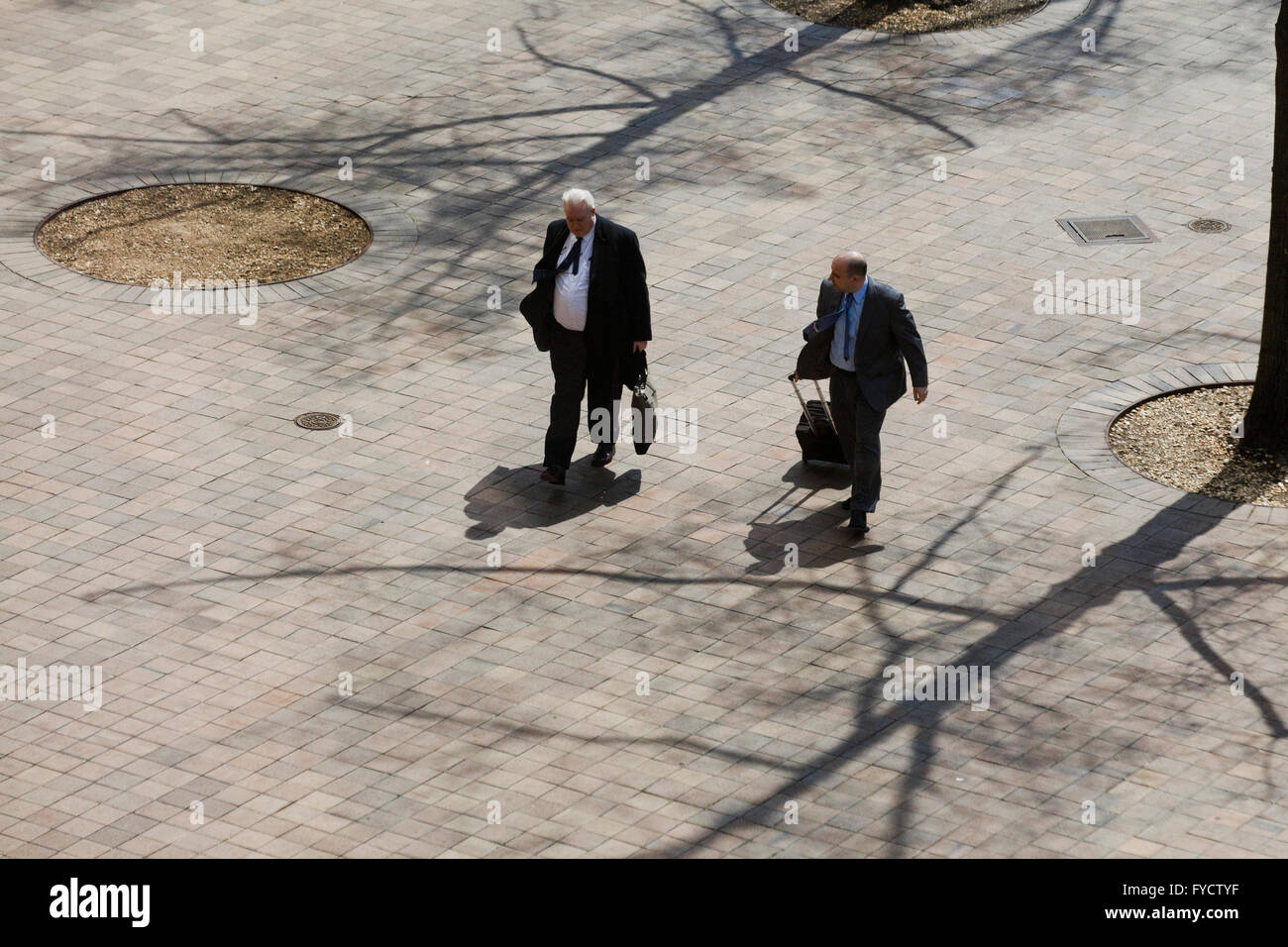 Elderly businessmen walking toward building - USA Stock Photo