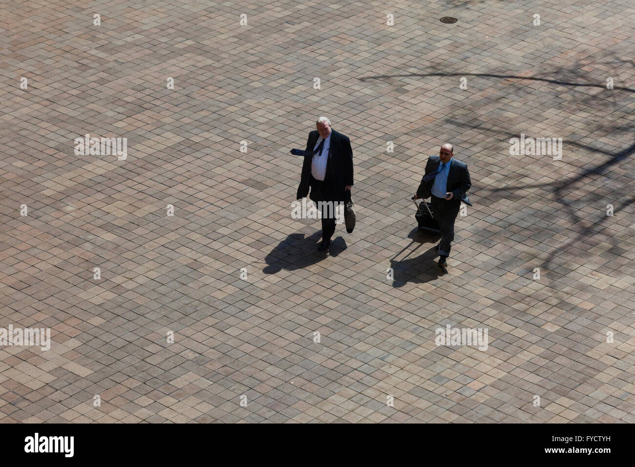Elderly businessmen walking toward building - USA Stock Photo