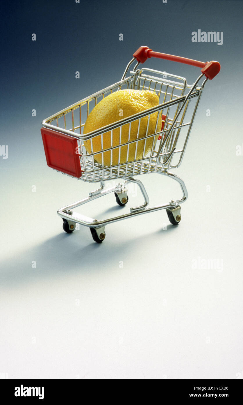 Shopping-cart with huge lemon Stock Photo