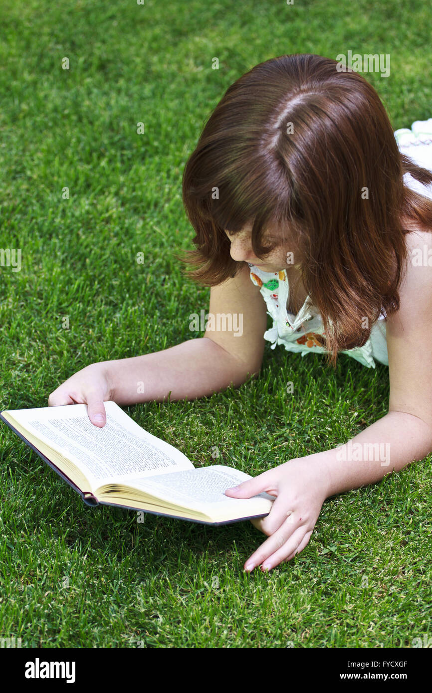 Young beautiful girl reading a book outdoor Stock Photo