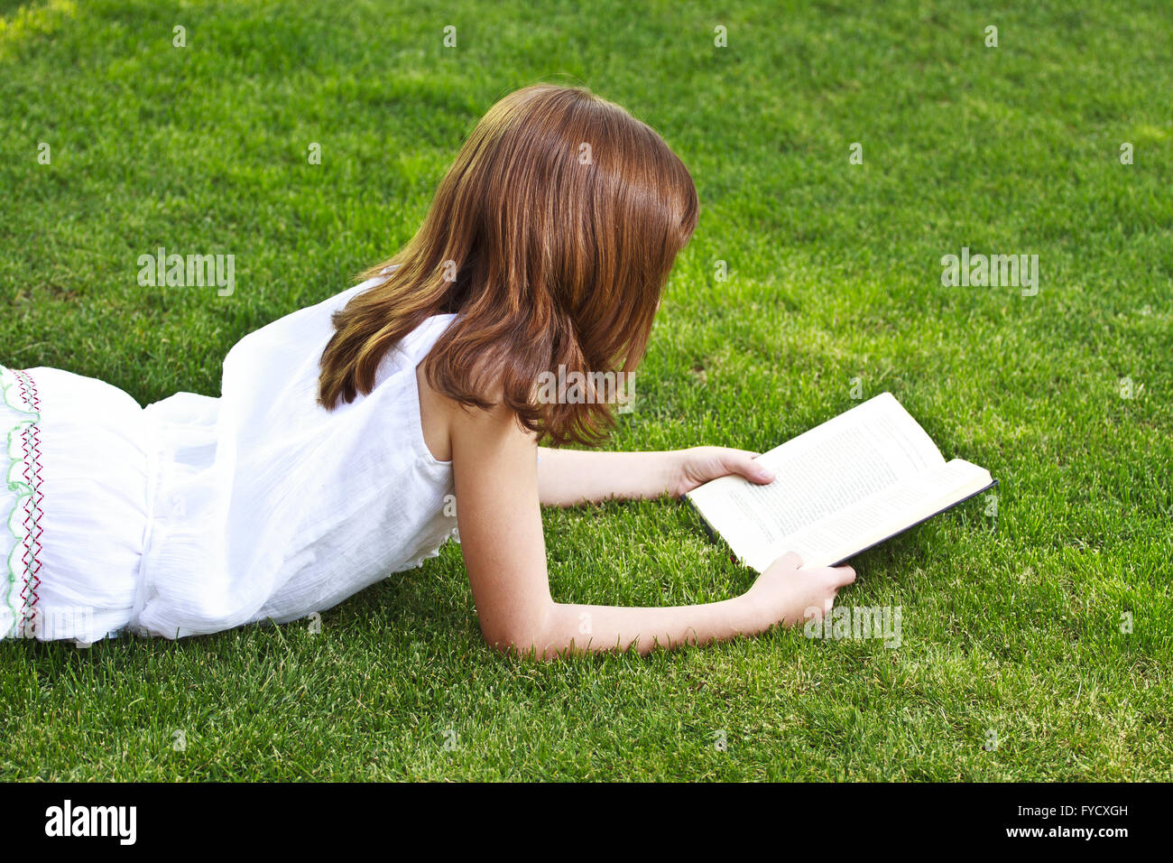 Young beautiful girl reading a book outdoor Stock Photo