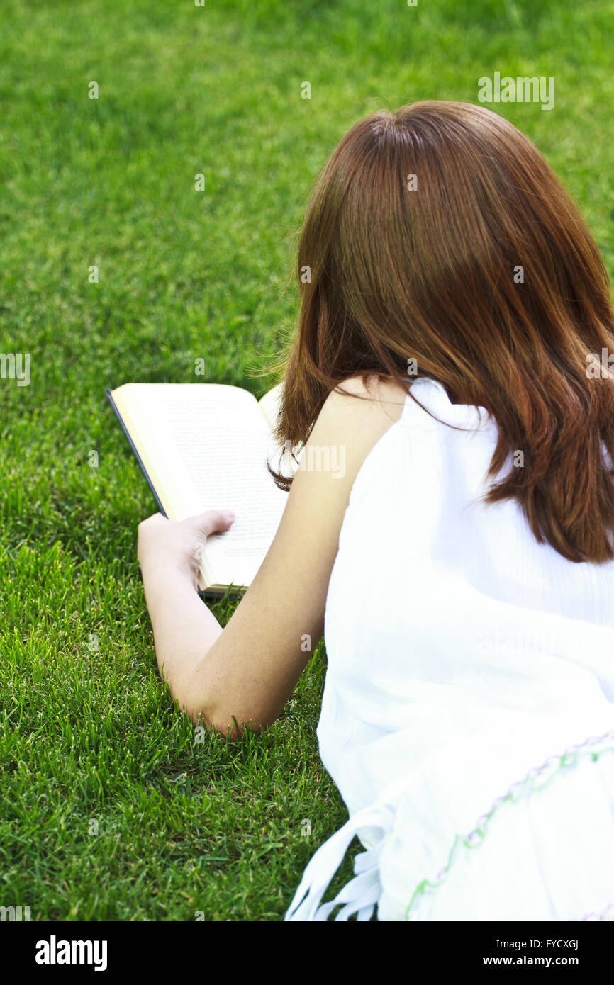 Young beautiful girl reading a book outdoor Stock Photo