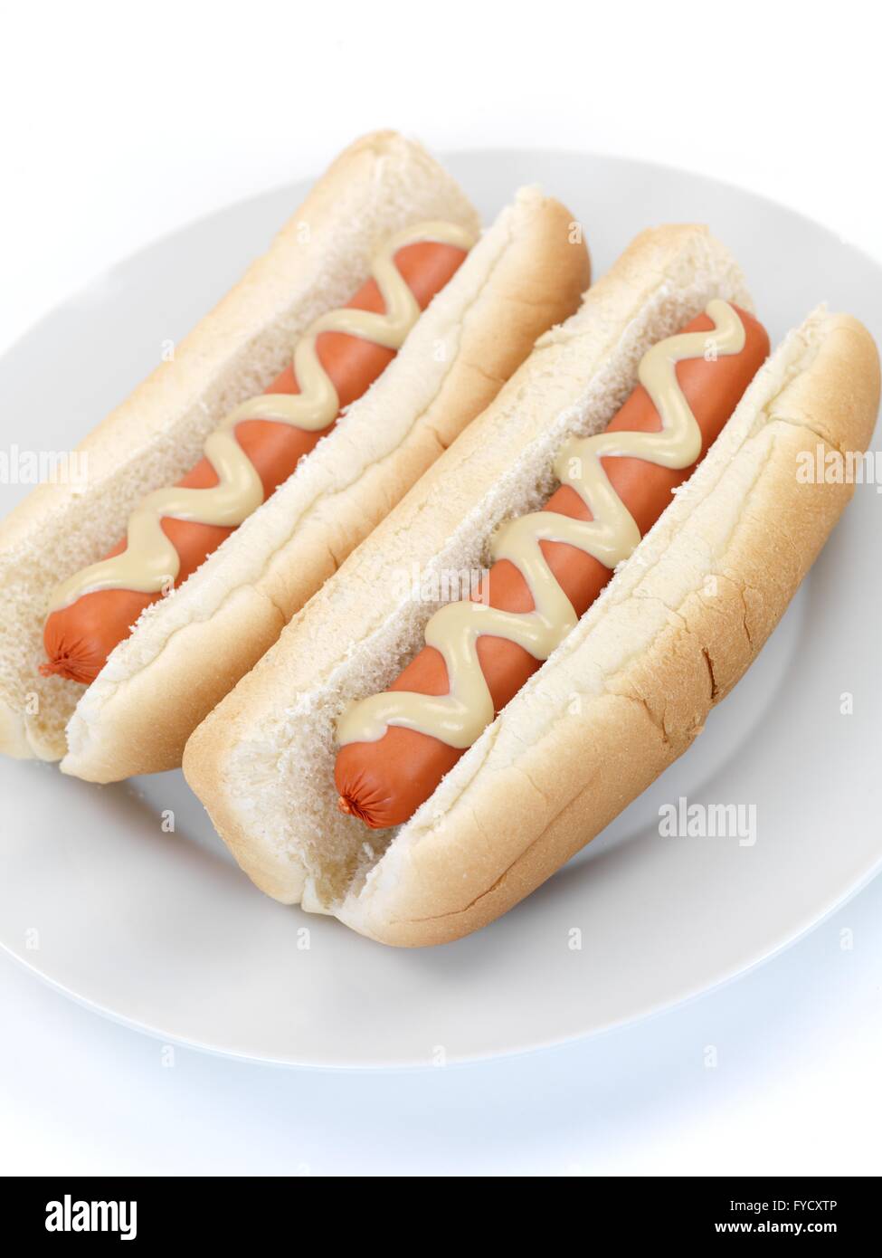 A hotdog with mustard sauce on a kitchen bench Stock Photo