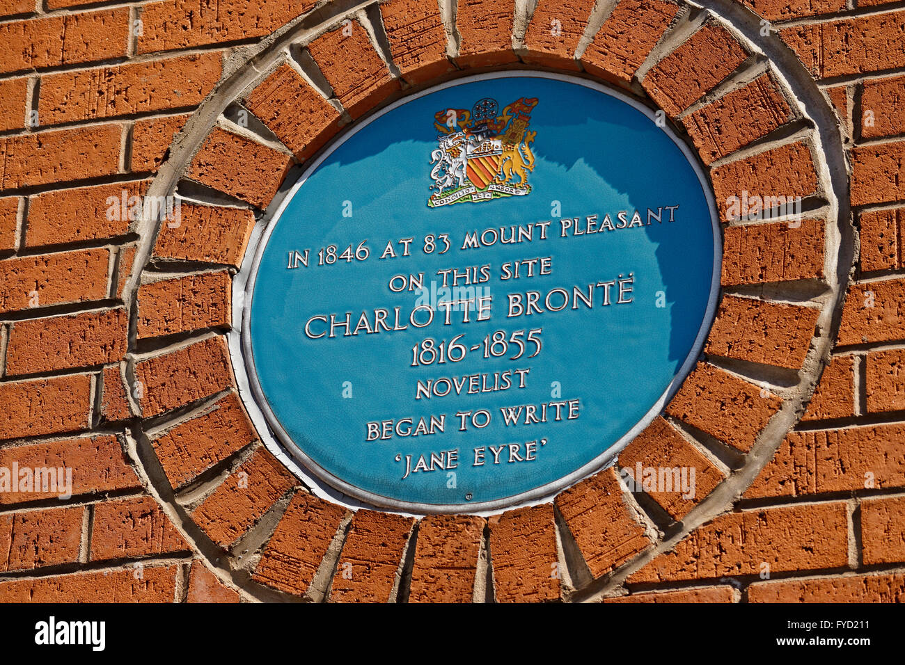 Commemorative blue plate at Hulme, Manchester, celebrates where Charlotte Bronte wrote the early parts of her novel 'Jane Eyre' Stock Photo
