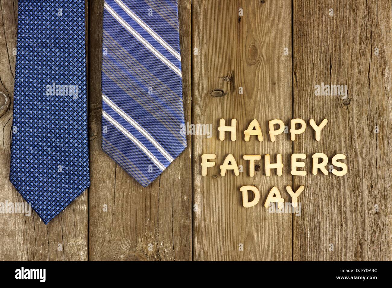 Happy Fathers Day wooden letters on a rustic wooden background with blue ties Stock Photo