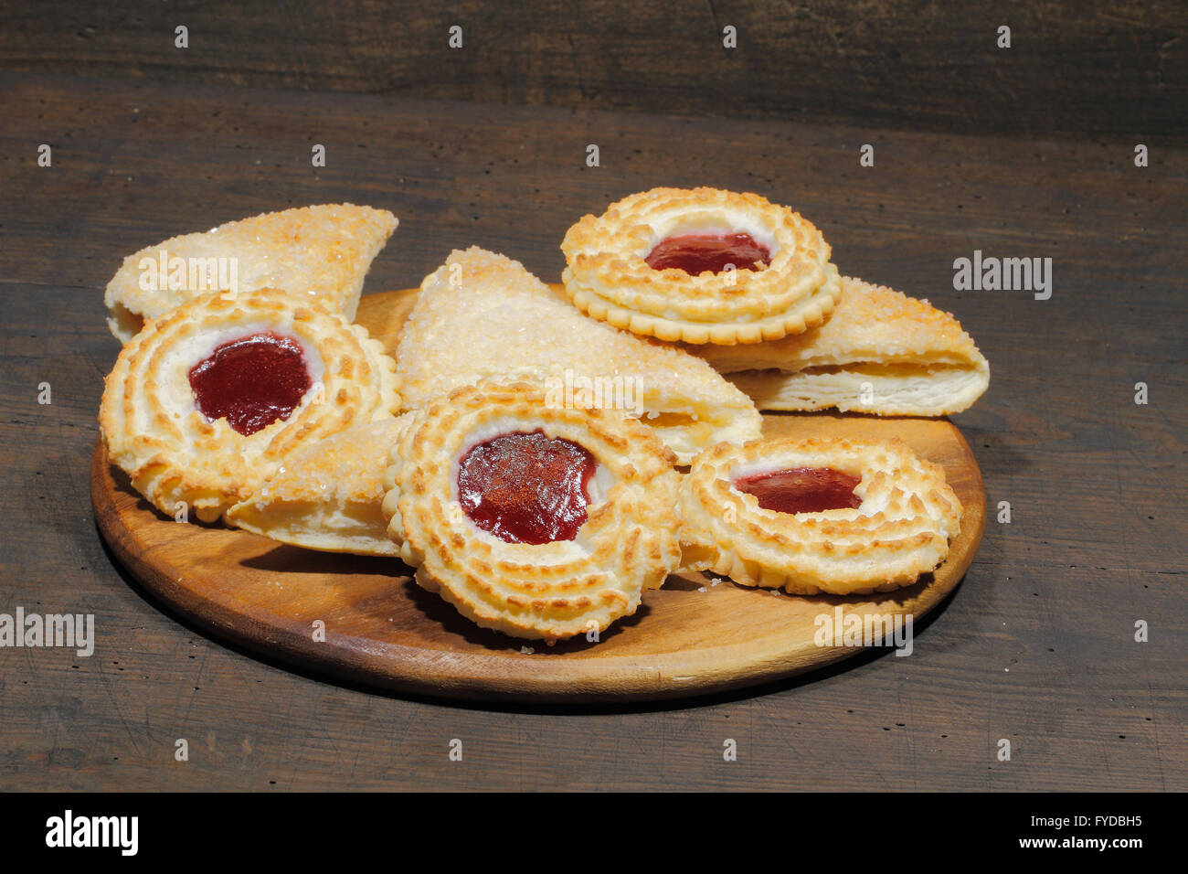 With apple stuffed dumplings and coconut tartlets on a rustic, wooden surface Stock Photo