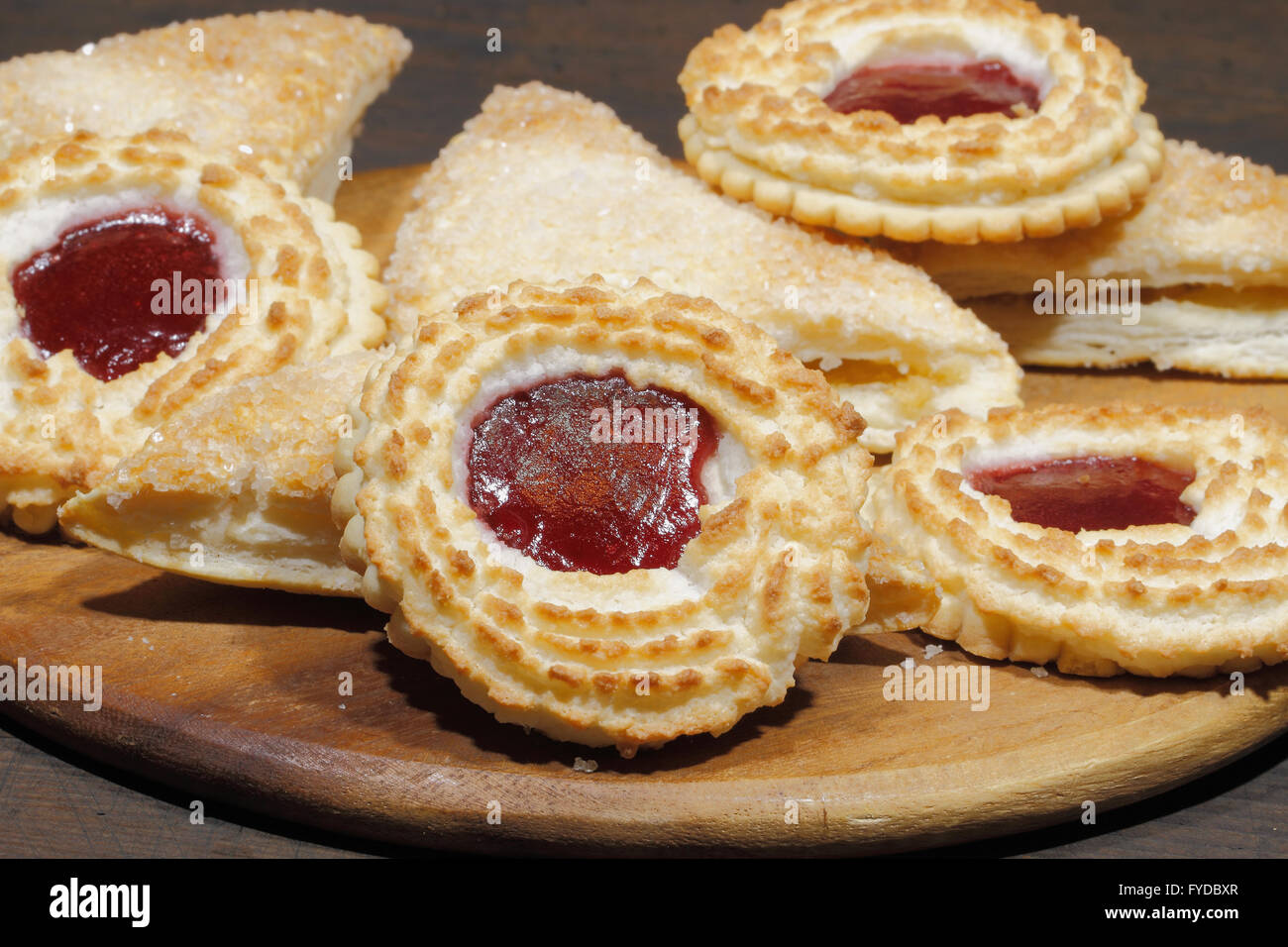 With apple stuffed dumplings and coconut tartlets on a rustic, wooden surface Stock Photo
