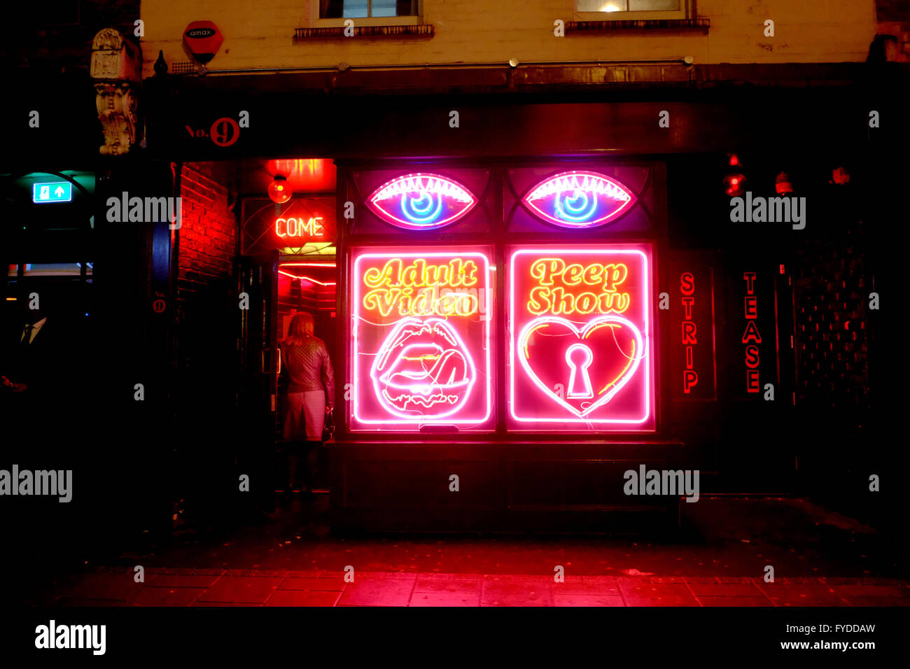 Woman entering Adult Video, Peep Show, Strip Tease, Sex store in Soho, London Stock Photo image
