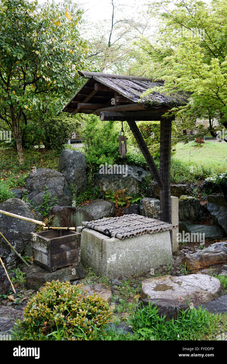 Traditional ancient stone well in japanese garden Stock Photo