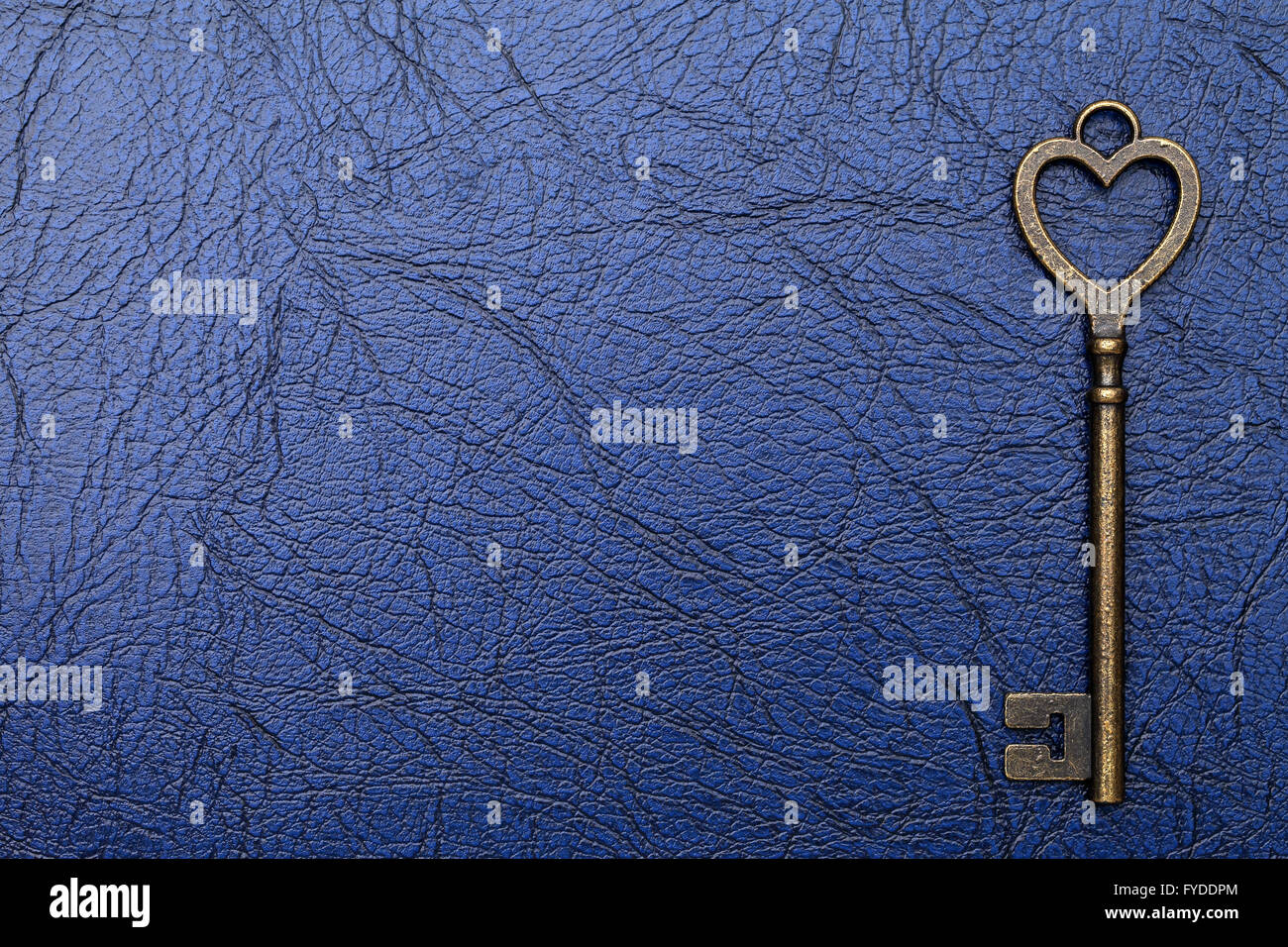 heart shaped vintage key on a leather background Stock Photo - Alamy