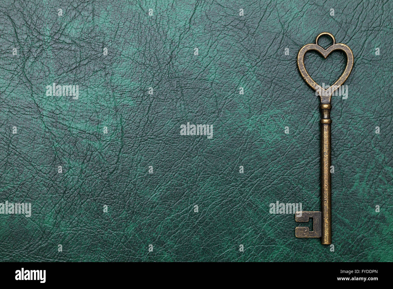 vintage key heart shape on green leather background Stock Photo - Alamy