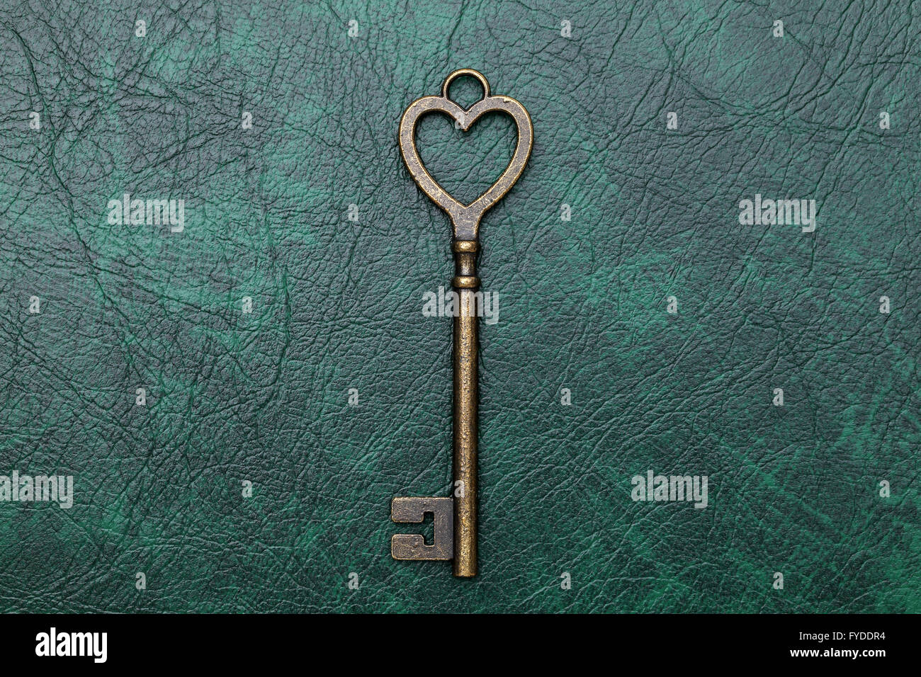 vintage key heart shape on green leather background Stock Photo - Alamy