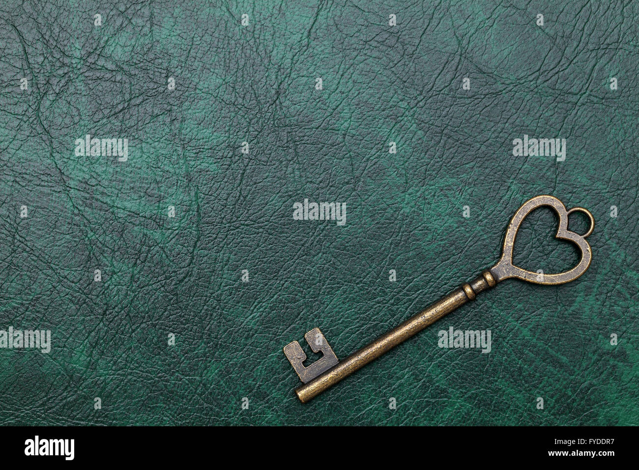 vintage key heart shape on green leather background Stock Photo - Alamy
